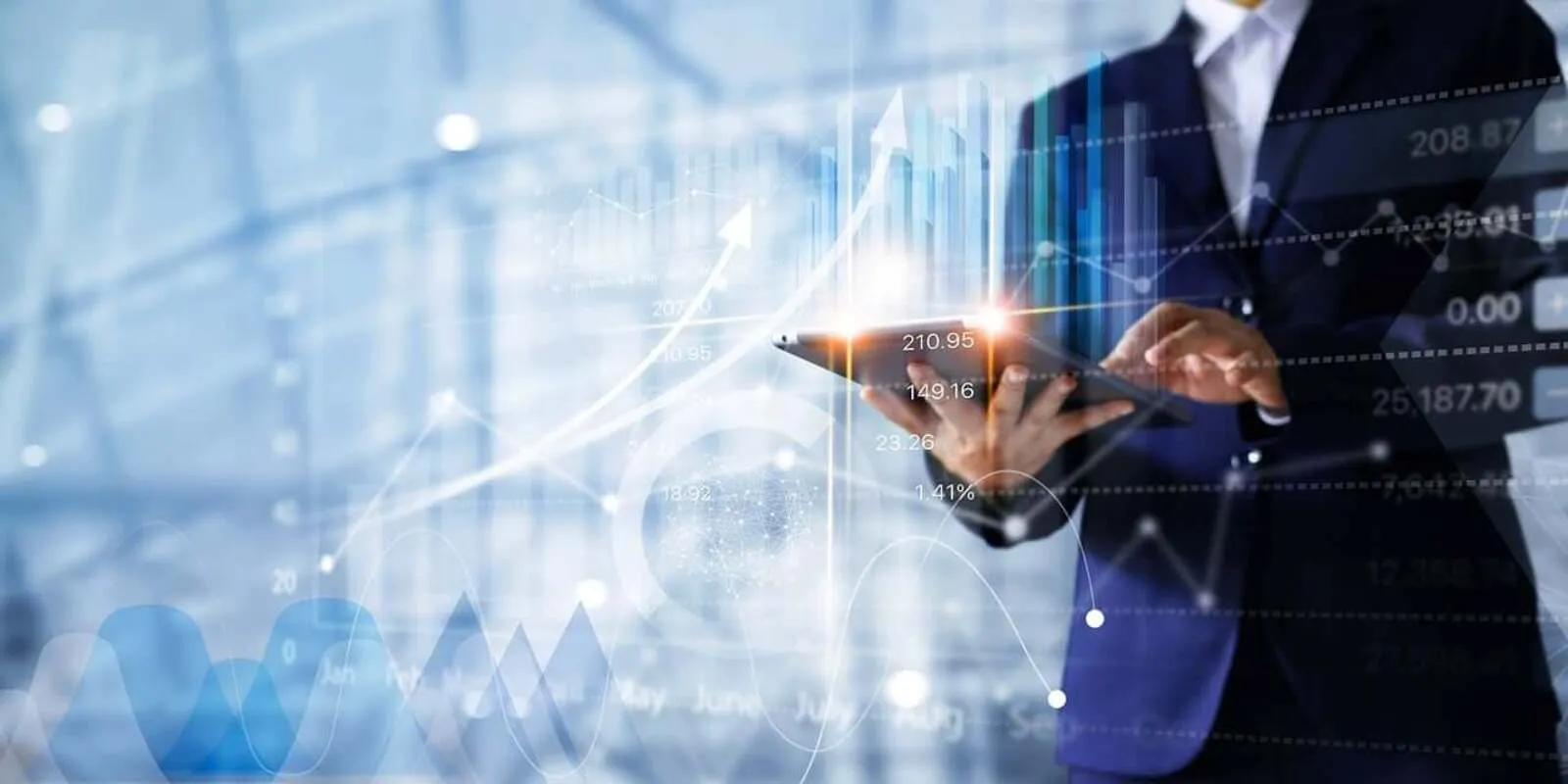 Dubai Business Setup - Person analyzing financial graphs on digital tablet with futuristic overlay.